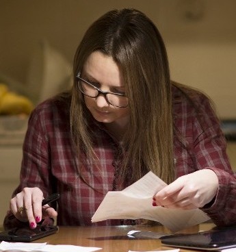 Woman Paying Bills in Jacksonville, Florida